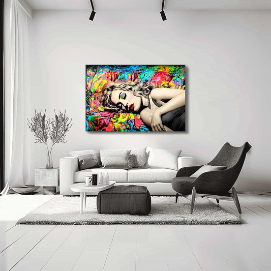 Living room wall art of Madonna lying down with her eyes closed in a black dress, set against a vibrant backdrop of blue, red, and yellow graffiti. Title: Graffiti Lullaby-Graphique Addictions.