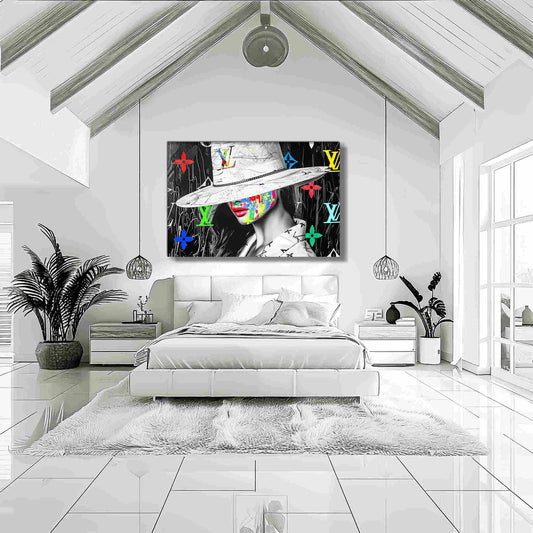 Bedroom wall decor of a woman with colorful graffiti on her face, wearing a wide-brimmed white hat and Louis Vuitton logos in background. Luxury meets graffiti, graphique addictions.