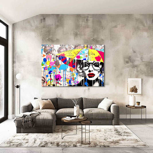 Living room wall decor of a woman holding an umbrella, wearing black glasses and surrounded by colorful paint splatters and graffiti symbols. Painted Rain Pop-Graphique Addictions.