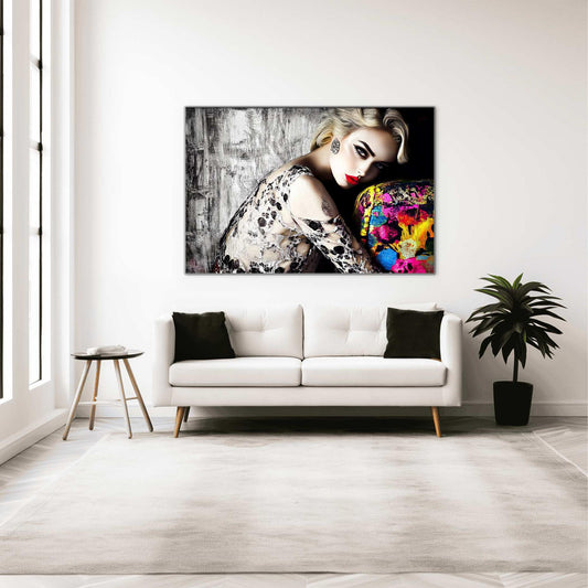 Living room mockup of a blonde model with bold red lips, wearing a black-and-white lace dress, leaning against a colorful sofa with a textured black-and-white wall in the background. Red Lips and Lace-Graphique Addictions.