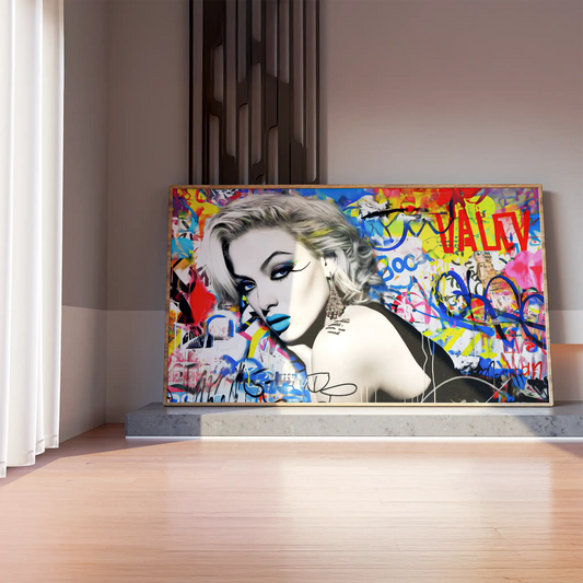 Mockup of woman lying on her stomach, surrounded by vibrant graffiti, wearing blue lipstick and winged eyeliner, in a black dress. Titled: Graffiti Dreamscape-Graphique Addictions.