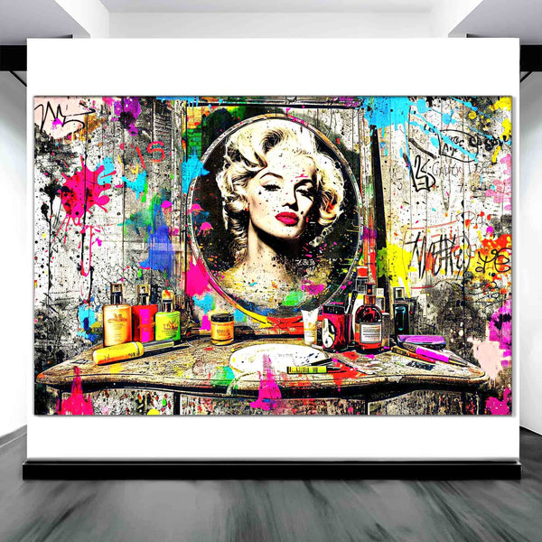Art display of Marilyn Monroe's reflection in a mirror, against an old wooden vanity table covered with makeup, perfume bottles, and colorful graffiti and paint. Marilyn's Painted Mirror-Graphique Addictions.