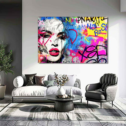 Living room wall art featuring a woman's face decorated with bold graffiti, set against a vibrant background of blue, yellow, and pink graffiti colors. Title: Graffiti Femme Fantasy-Graphique Addictions.