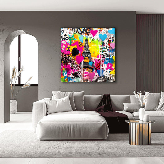 Living room graffiti wall art of the Eiffel Tower with colorful splashes, drips, and bold hearts in bright pink, blue, yellow, orange, and black-and-white. Title: Graffiti Paris-Graphique Addictions.
